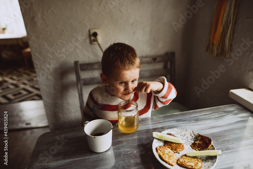 portrait of a child who eats honey photo