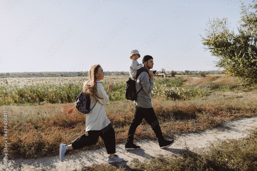 family with a child walking outside the city family with a child walking outside the city