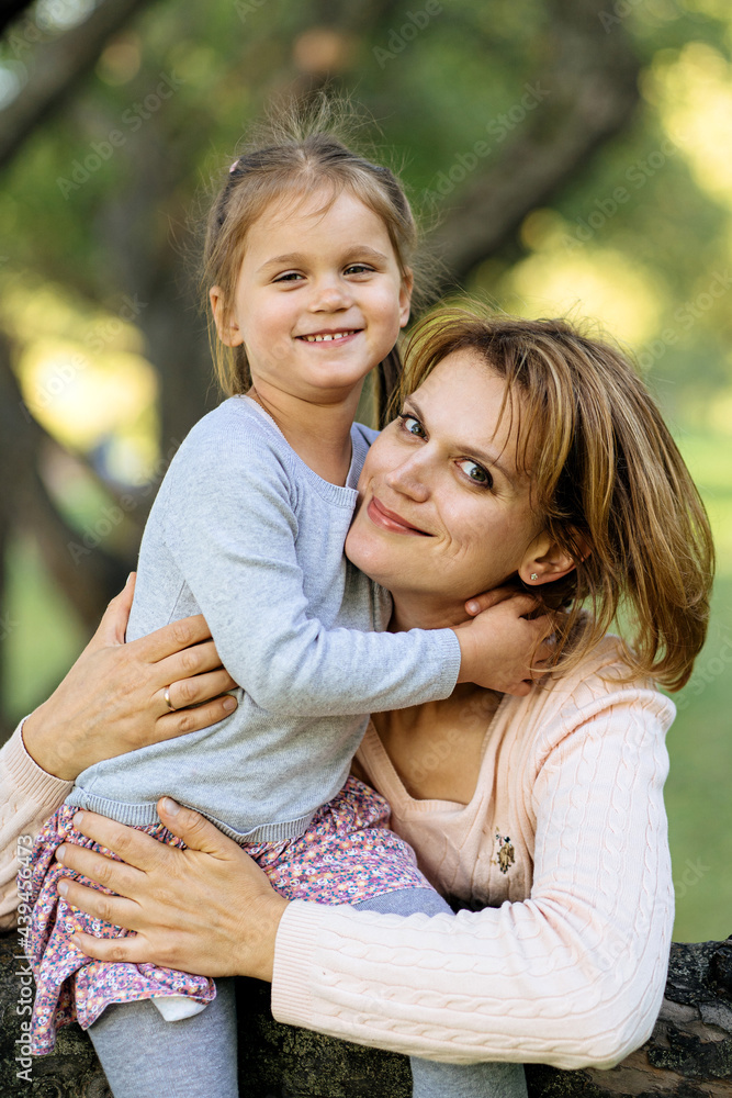© Ivan Ozerov/Stocksy - Mother and daughter hugging near tree © Ivan Ozerov/Stocksy - Mother and daughter hugging near tree