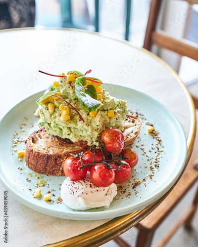 Smashed Avocado on an aqua plate photo