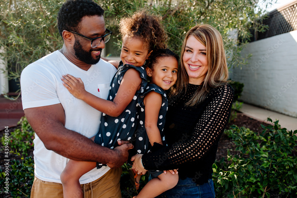 © Erin Brant/Stocksy - Happy family smiling at home
