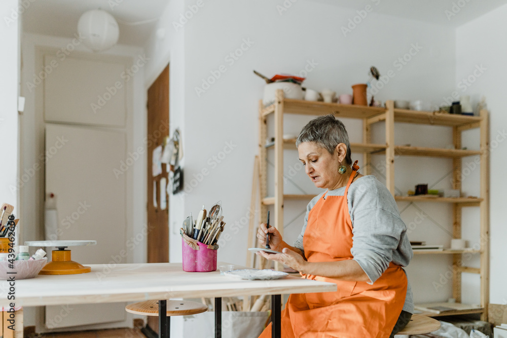 Woman working with pottery Woman working with pottery