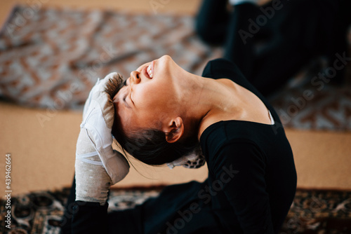 Little girl is engaged in rhythmic gymnastics in the gym through pain