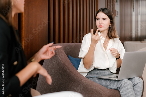 Deaf manager discussing project with deaf colleague