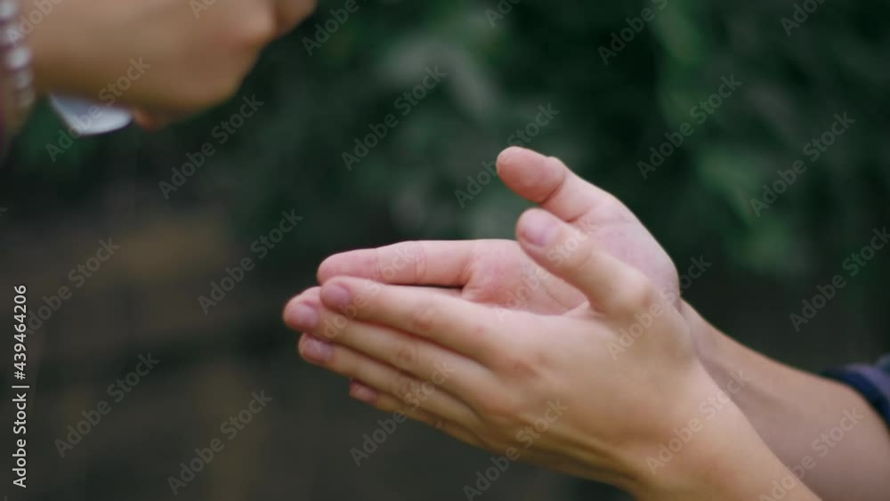 Mother disinfects her son's hands with alcohol gel for covid 19. Slow Motion. Mother disinfects her son's hands with alcohol gel for covid 19. Slow Motion.