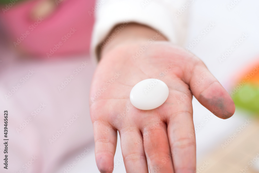 A white chess piece in the hands of a child A white chess piece in the hands of a child