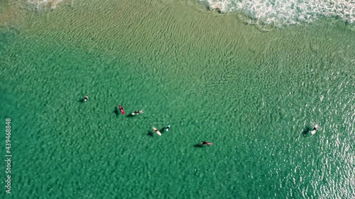 Drone aerial shot of Frazer Beach surfers waiting in crystal clear water Pacific Ocean Central Coast NSW Australia 3840x2160 4K photo