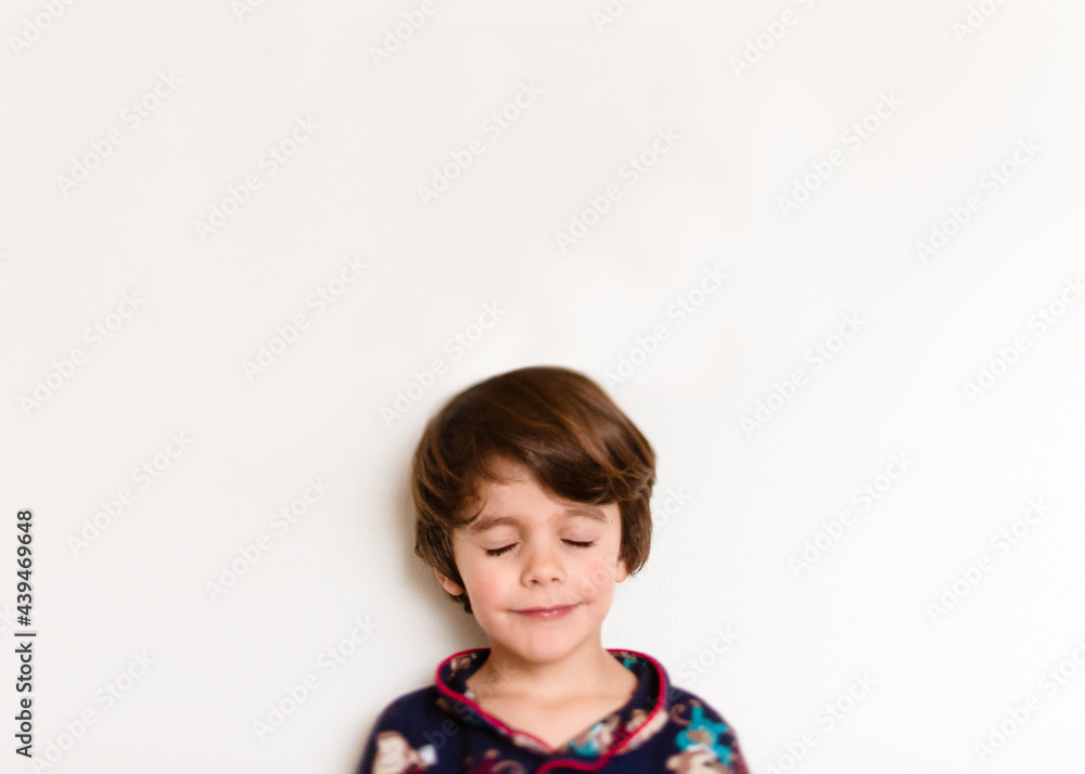 portrait of boy smiling with eyes closed portrait of boy smiling with eyes closed
