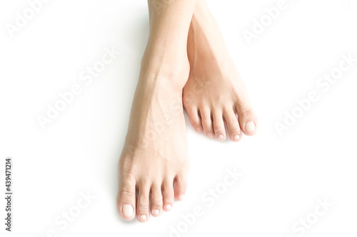 Fototapeta Naklejka Na Ścianę i Meble -  Beautiful female legs and feet on a white background.
