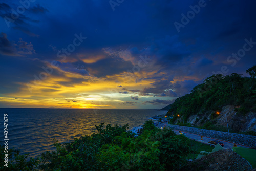 Fototapeta Naklejka Na Ścianę i Meble -  Sunset twilight and beautiful curved road of the sea at Noen Nangphaya view point in Kung Wiman, Chanthaburi, Thailand.