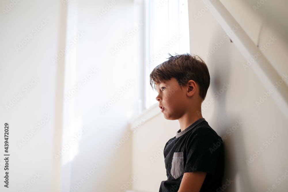 Young boy inside home and bored Young boy inside home and bored
