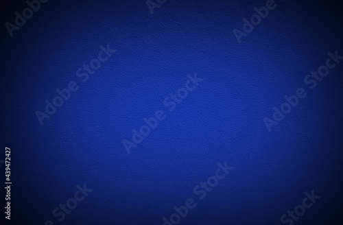 blue desk texture with black gradient background with space for text.