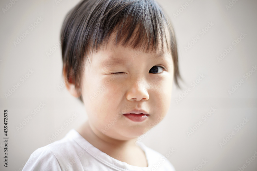 Close-up funny head portrait of cute Asian kid with clean background at home. Close-up funny head portrait of cute Asian kid with clean background at home.