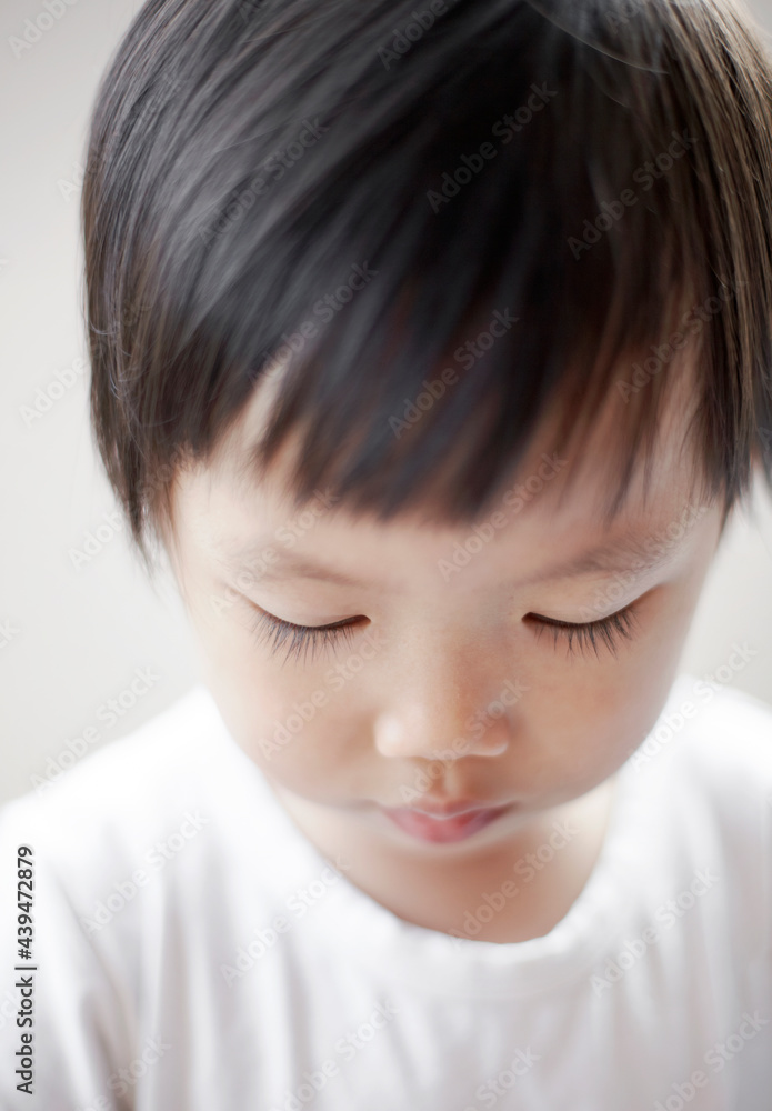 Close-up funny head portrait of cute Asian kid with clean background at home. Close-up funny head portrait of cute Asian kid with clean background at home.