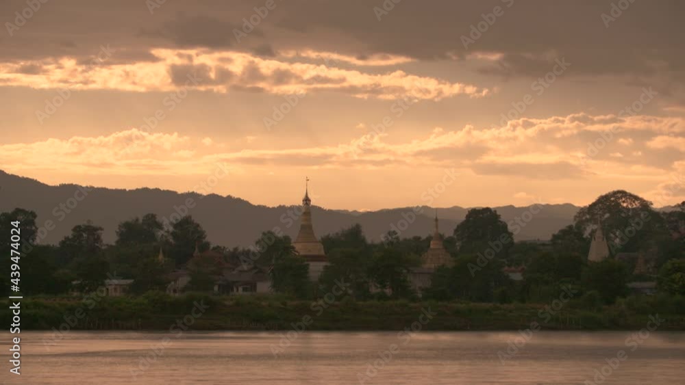 Dusk in Myanmar Countryside at the Irrawaddy River with Temple and Mountains Calm Scenery Dusk in Myanmar Countryside at the Irrawaddy River with Temple and Mountains Calm Scenery