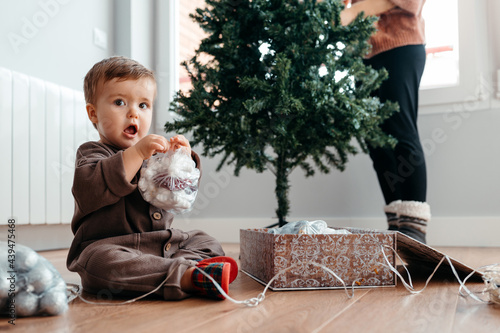 Lovely baby with Christmas ornaments. photo