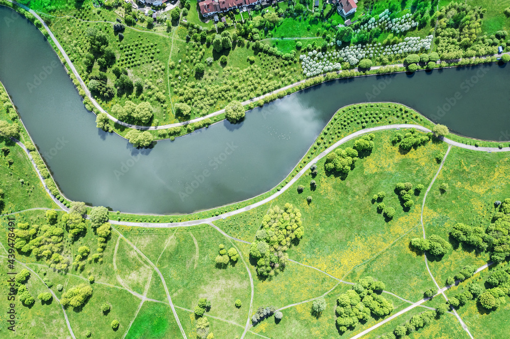 walking paths along river in summer park. top view aerial photo from flying drone.