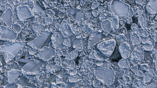 overhead view of a frozen river with ice flows