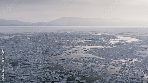 overhead view of a frozen river with ice flows