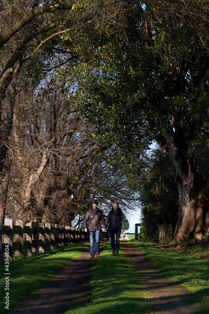 Mature Lesbian couple Walking hand in hand along a path Mature Lesbian couple Walking hand in hand along a path