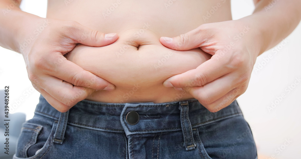 Naklejka premium hand pinch excessive belly fat