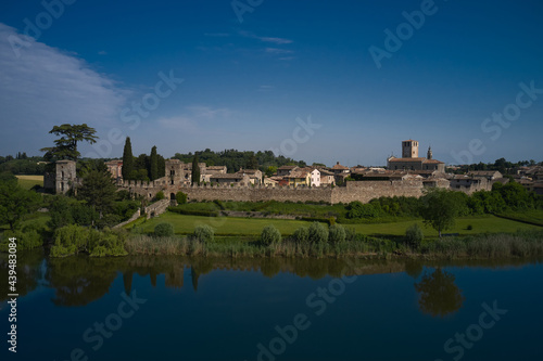 Aerial view of the Italian medieval castle Castellaro Lagusello. Panoramic aerial view of Castellaro Lagusello castle on Lagusello lake. Classic Italian medieval villa VILLA TACOLI ARRIGHI, Italy.