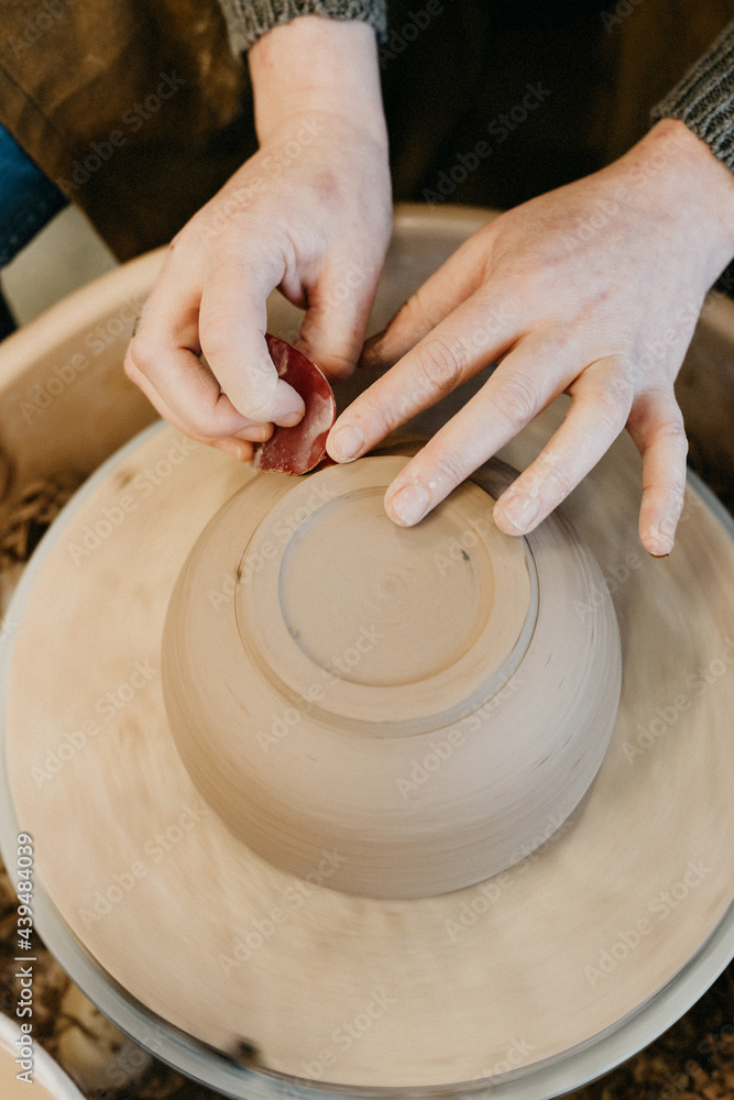 Finishing off a cup on the turning weel Finishing off a cup on the turning weel