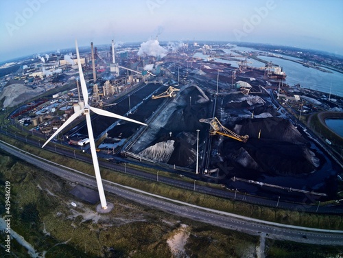 Aerial, windmills vs coal carbon economy - fossil fuel & clean energy sources