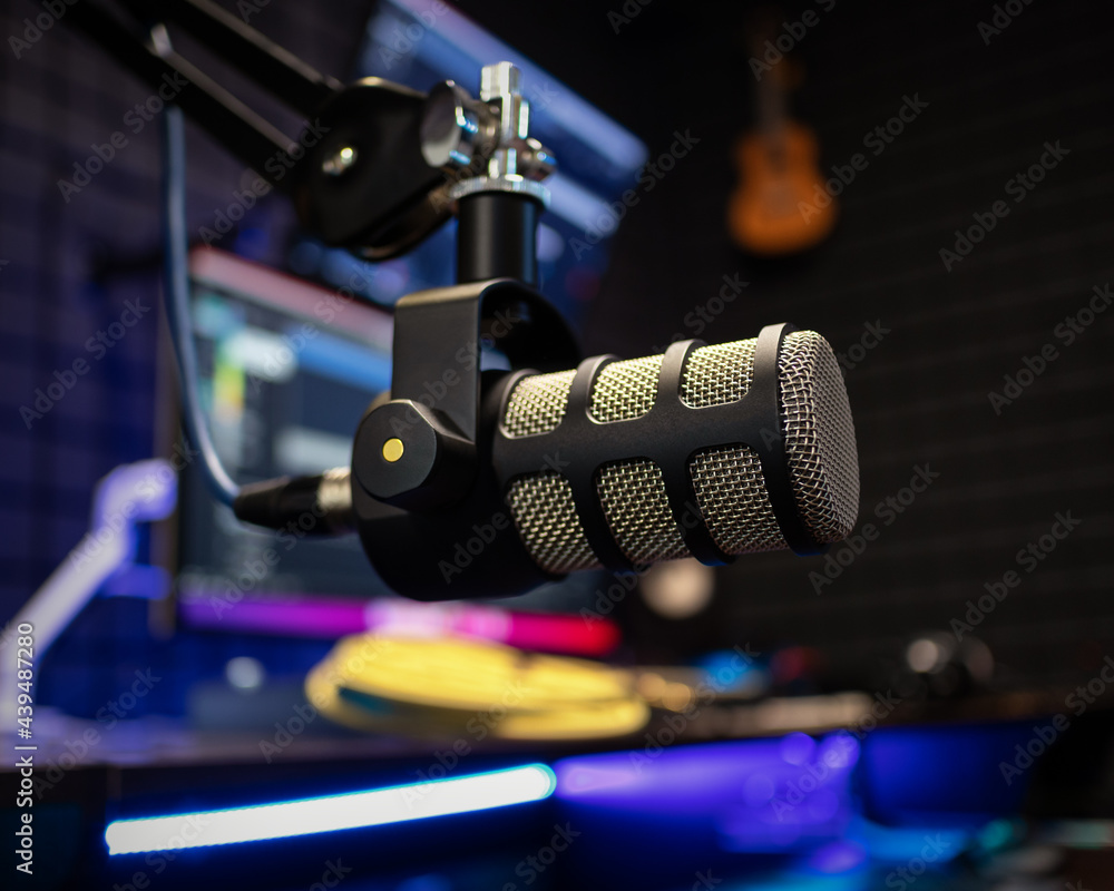 Professional studio condenser microphone in modern music recording studio on a sound acoustical foam background in recording studio