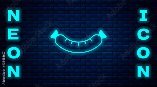 Glowing neon Sausage icon isolated on brick wall background. Grilled sausage and aroma sign. Vector