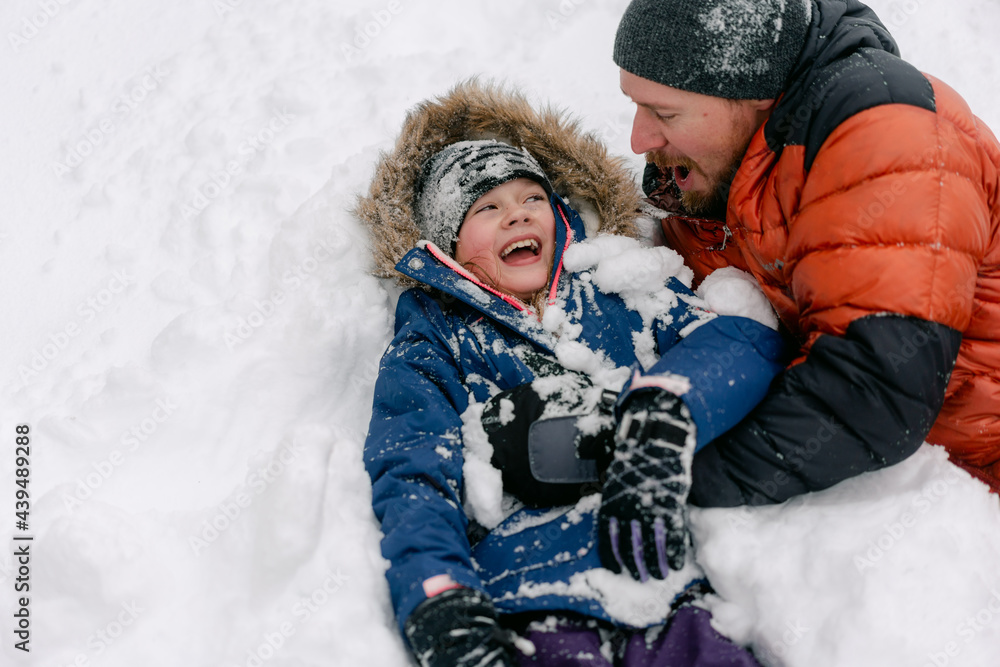 father and daughter having fun in the snow father and daughter having fun in the snow