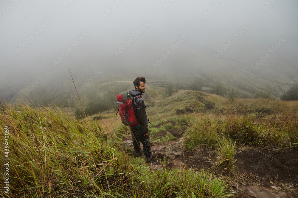 A man with a backpack on a background of mountains A man with a backpack on a background of mountains