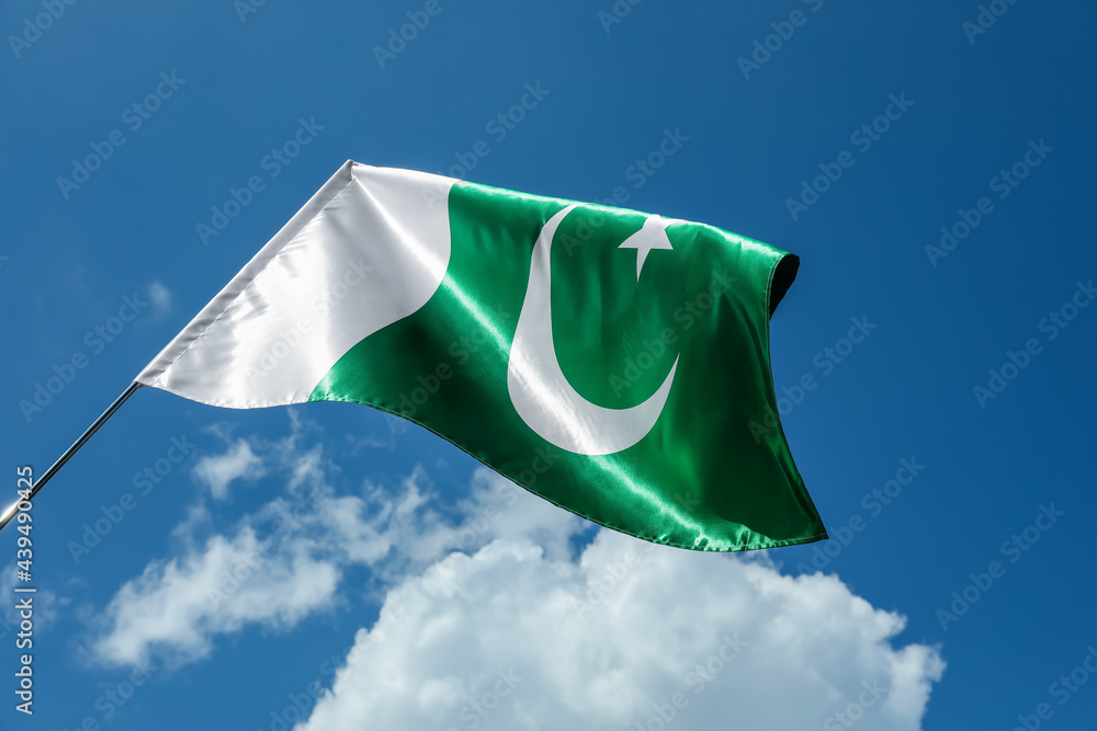 Pakistan flag outdoors against blue sky