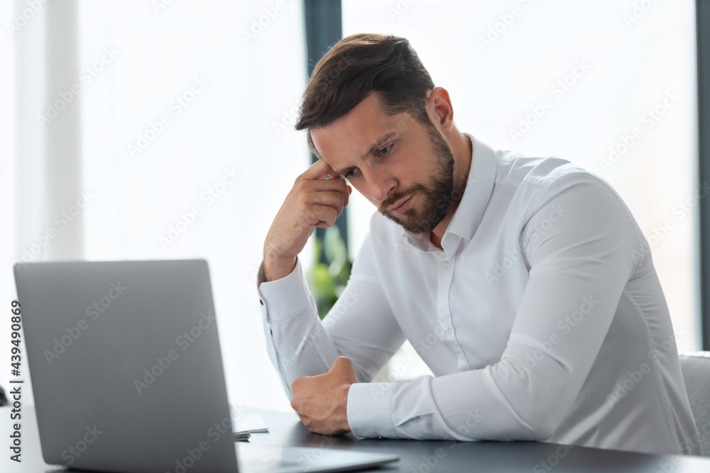 Poor financial result of the month, Frustrated businessman looking at laptop screen, analyzing bad sales month, sitting at work table in office, bankrupt Poor financial result of the month, Frustrated businessman looking at laptop screen, analyzing bad sales month, sitting at work table in office, bankrupt