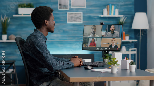 African american man on online internet conference chat with his coworkers, remote working from home, using teleconference web communication with webcam. Black guy distance technology talking
