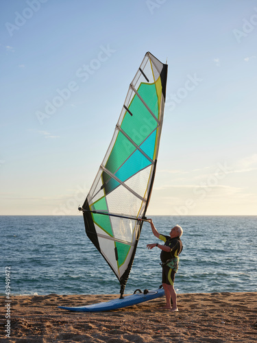 Aged sportsman ready for windsurf photo