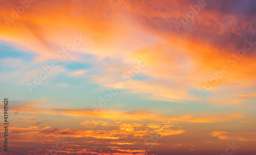 Beautiful glowing pink and golden cirrus clouds after storm at sunset, colorful dramatic sunset cloudscape, soft sunlight © kucherav
