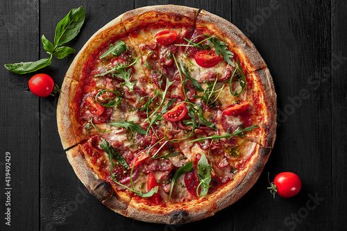 Top view of pizza with pelati sauce, cabanossi, salami, bacon, ham #439492429