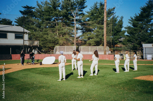 Film crew and actors on a baseball field photo