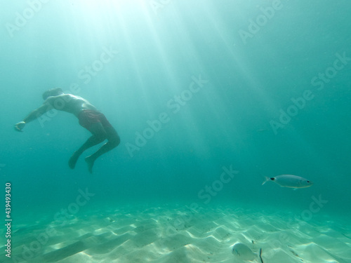 underwater man snorkeling in the sea withcrystal-clear waters concept of holiday relax summer beach diver in the sea © Enrique