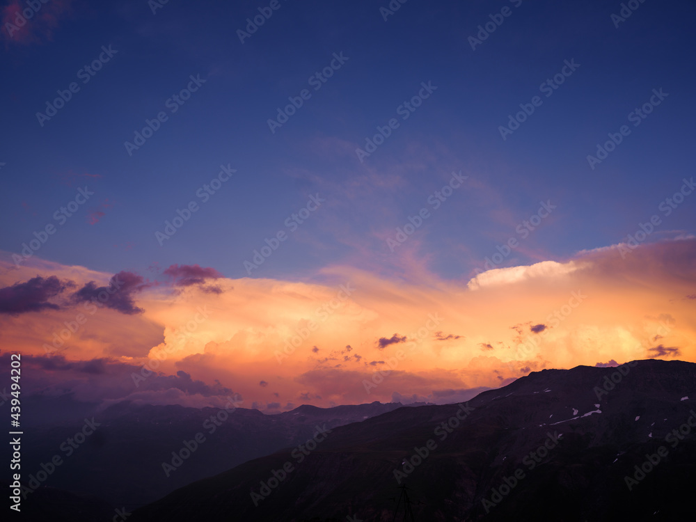Glowing clouds at sunset after a thunderstorm Glowing clouds at sunset after a thunderstorm