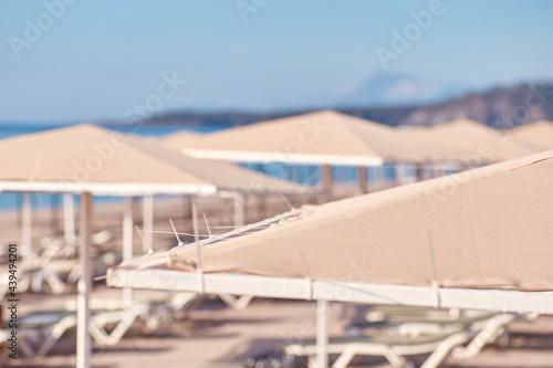 Beach umbrella or parasol on sunny weather near Mediterranean Sea. Protective concept. High quality photo