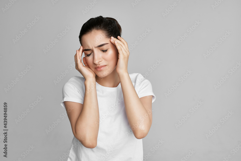woman in white t-shirt holding face dissatisfaction problem isolated background woman in white t-shirt holding face dissatisfaction problem isolated background