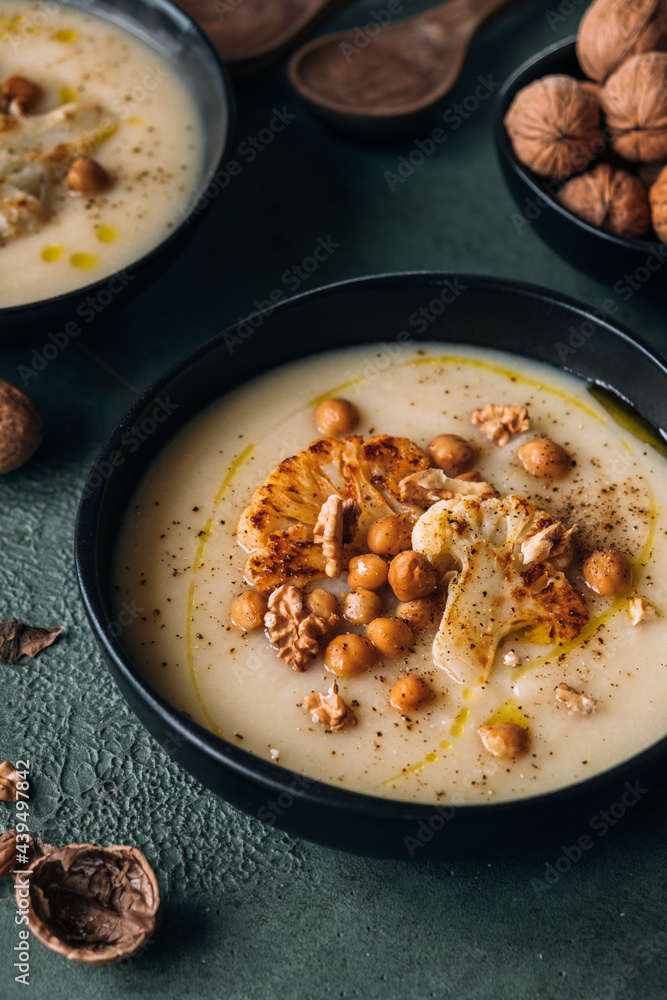 Cauliflower creamy soup topped with roasted cauliflower, chickpeas and walnuts Cauliflower creamy soup topped with roasted cauliflower, chickpeas and walnuts