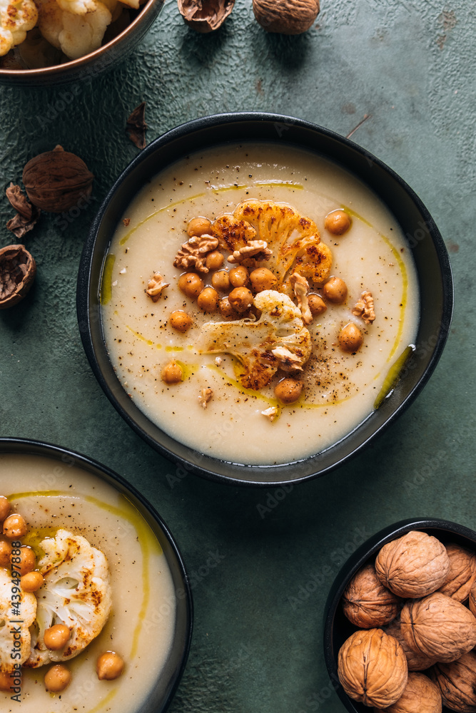 Cauliflower creamy soup topped with roasted cauliflower, chickpeas and walnuts Cauliflower creamy soup topped with roasted cauliflower, chickpeas and walnuts