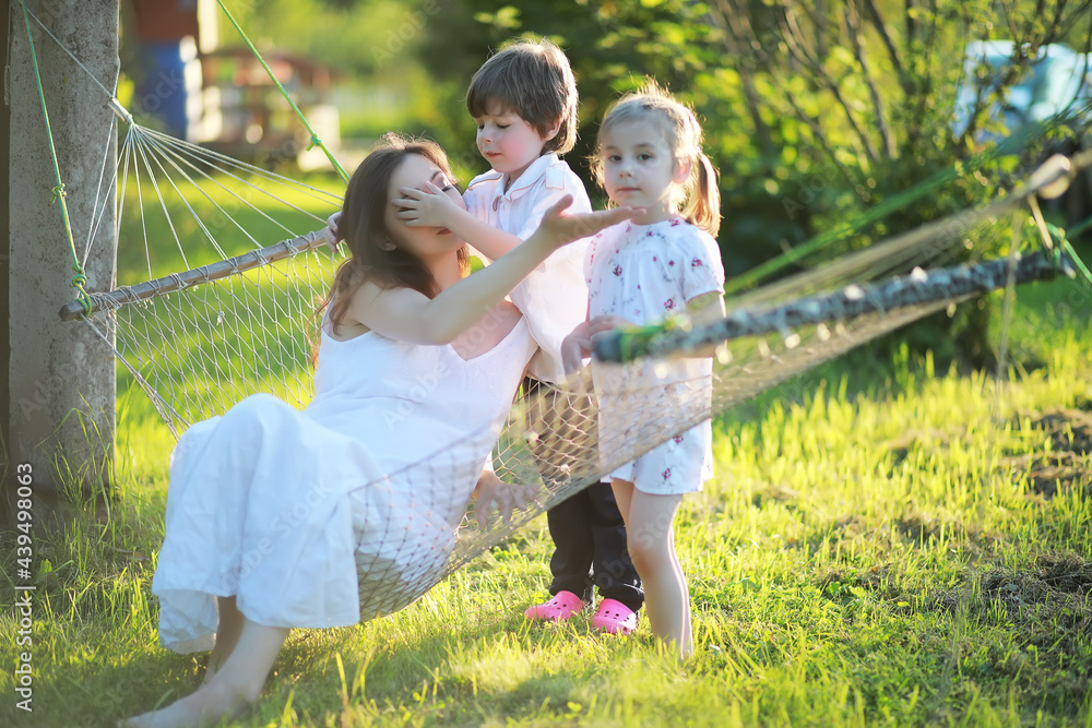 Fototapeta premium The family is resting in nature. Vacations in the fresh air. Weekend children play in the park.