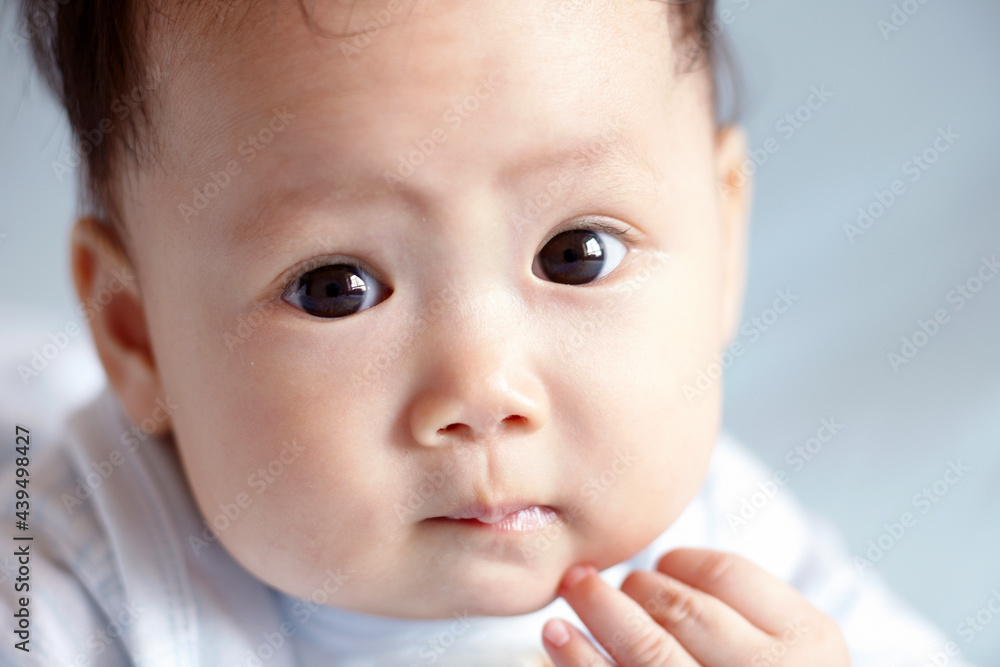 Close-up of a cute Asian baby playing on the bed Close-up of a cute Asian baby playing on the bed