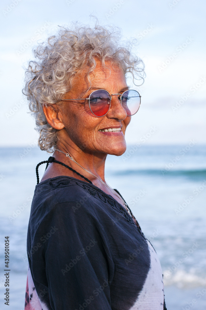 Smiling elderly woman in sunglasses on beach Smiling elderly woman in sunglasses on beach