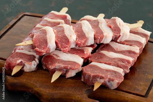 Lamb Steak on a dark background. Uncooked lamb meat.
