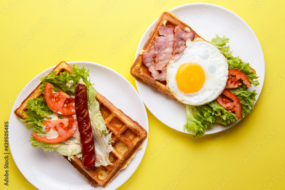 Waffle wholesome breakfast. Sour waffles with grilled sausages, fried eggs, delicious sauce and fresh vegetables.